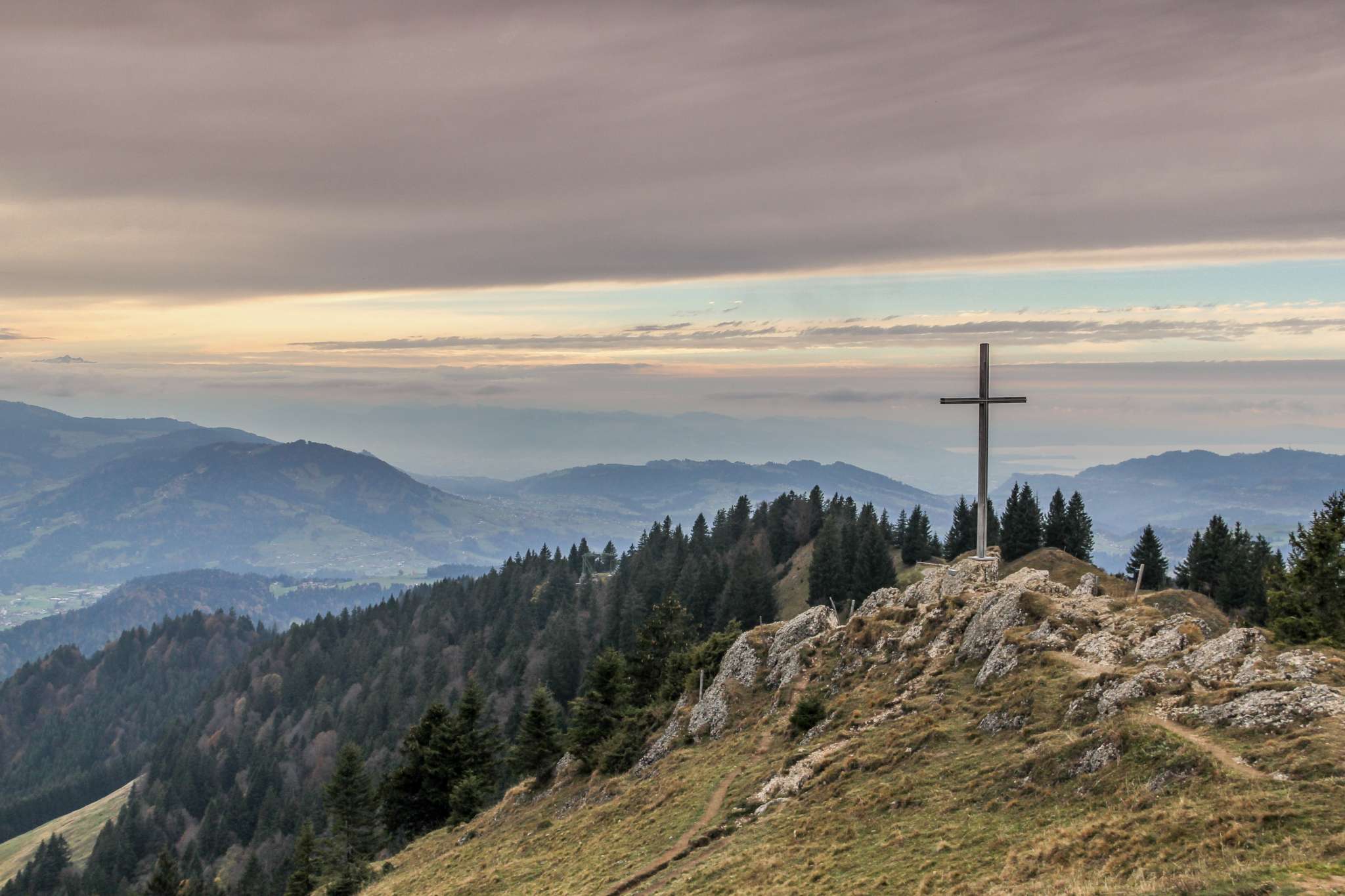 A cross planted atop a mountain