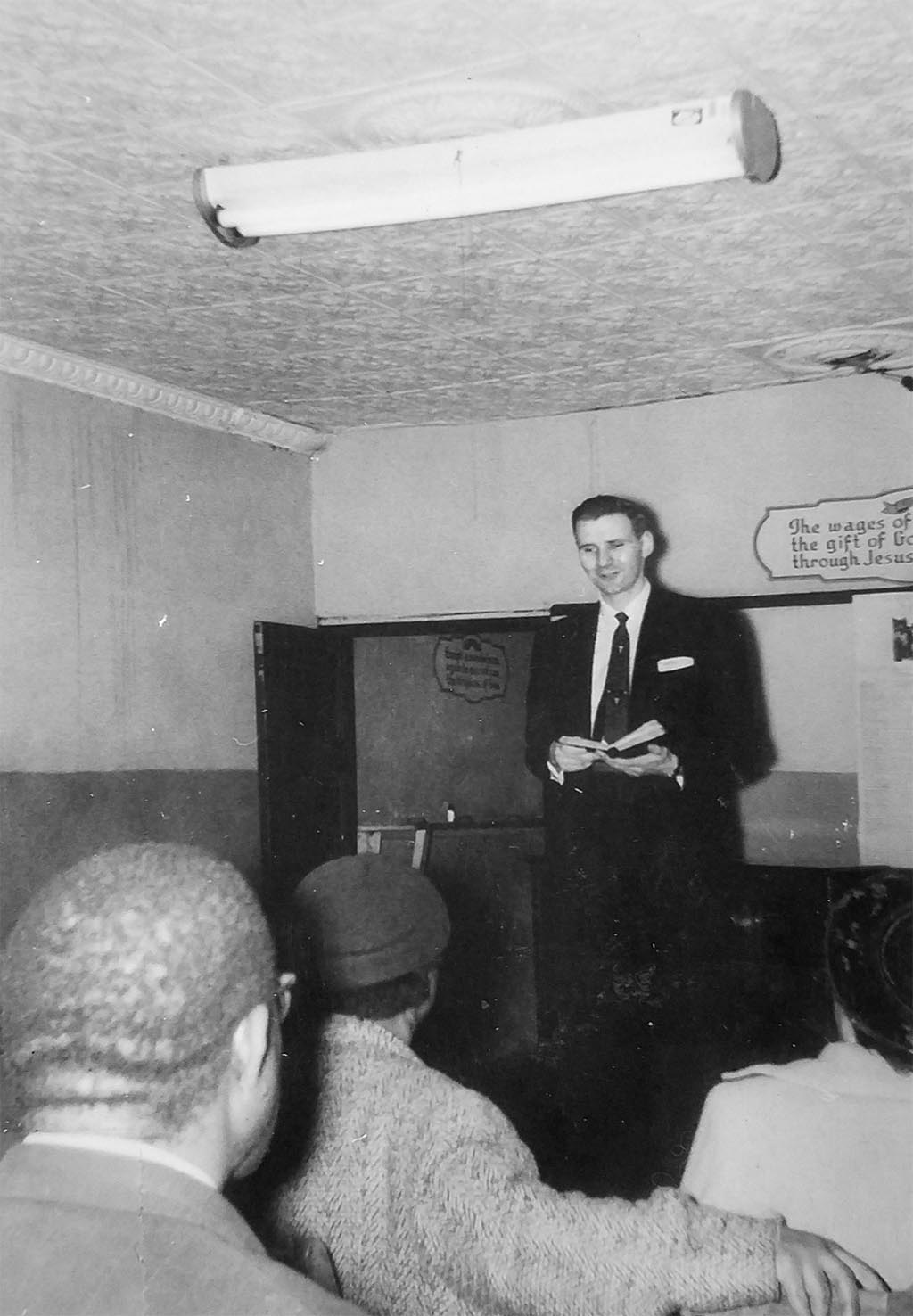 Raleigh Holt preaching to a group of men