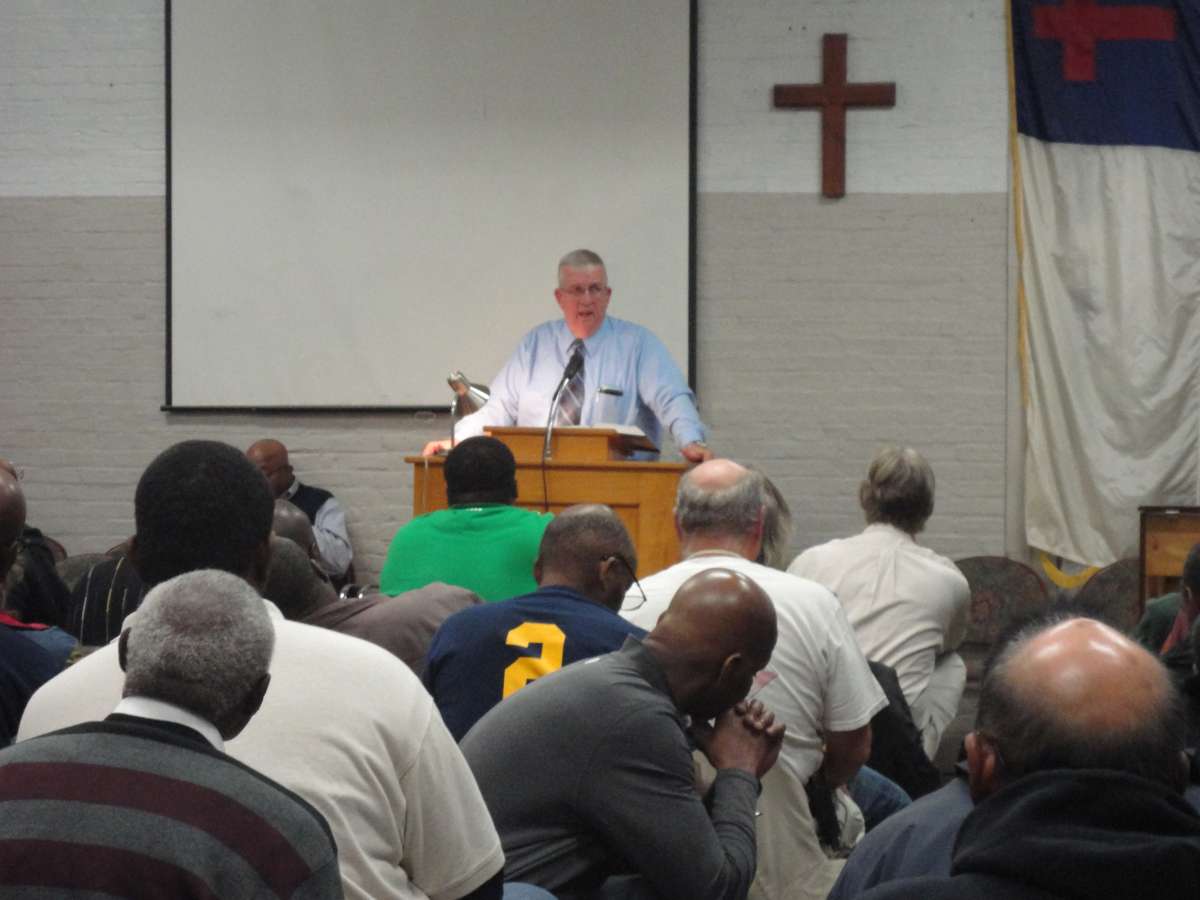 Pastor Charles Buettner addresses a group of men