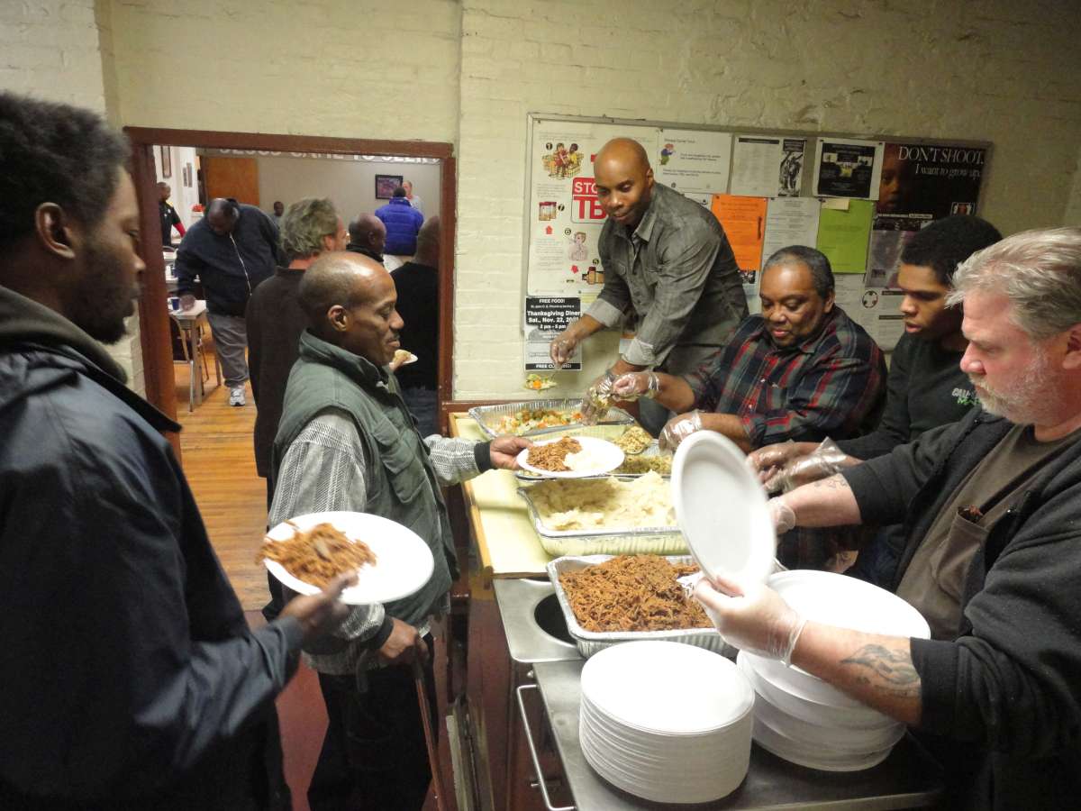 Men receiving meals from the mission's kitchen